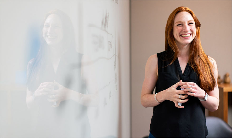 Woman presenting at whiteboard